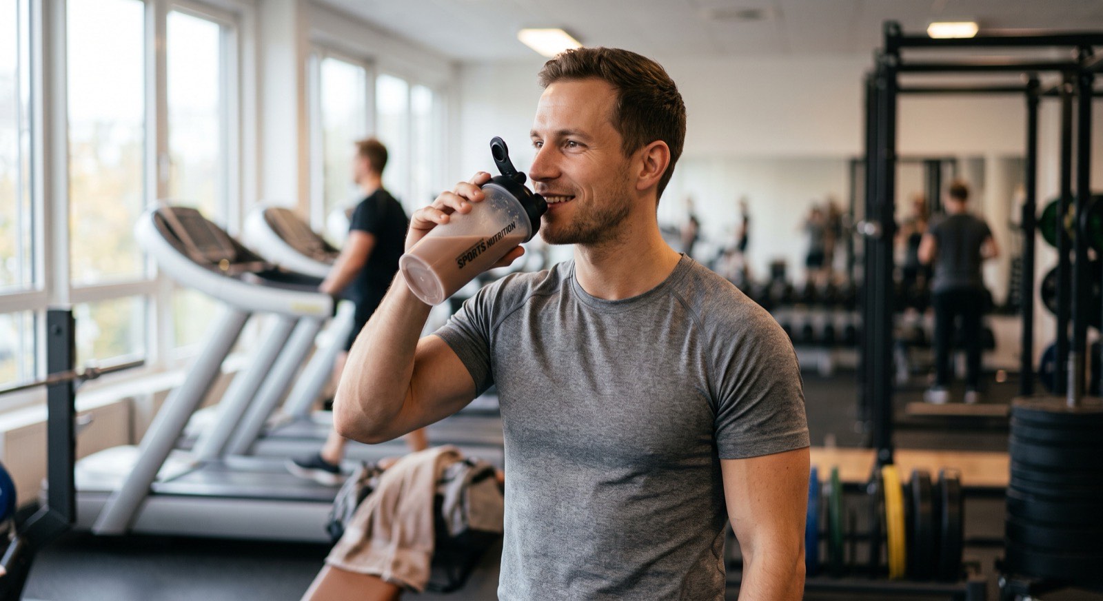 Athlete drinking a protein shake in a gym
